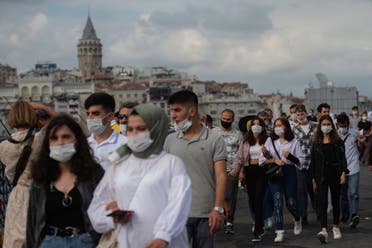 People wearing masks for protection against the spread of coronavirus, walk over Eminonu bridge in Istanbul, Friday, Sept. 11, 2020. (AP)