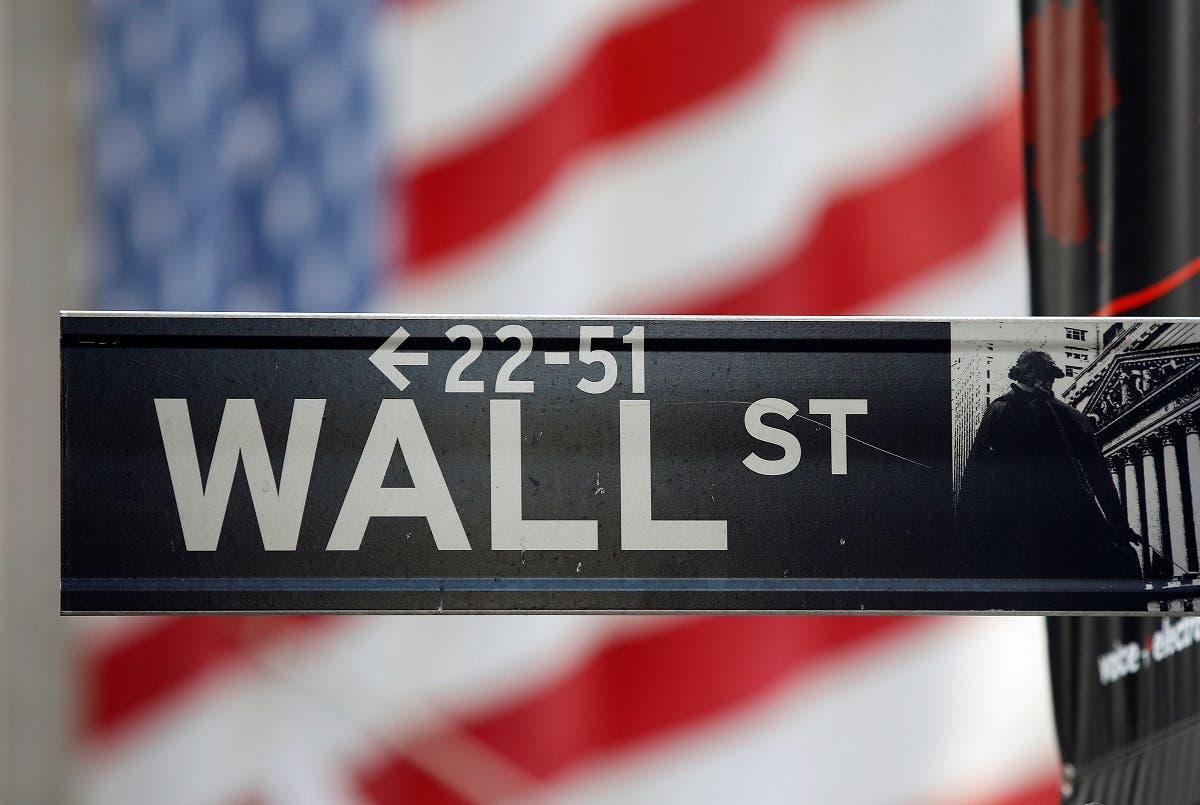 A sign for Wall Street is seen with an American flag in the background across from the New York Stock Exchange. (File Photo: Reuters)