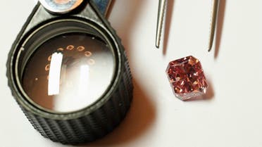 A Rio Tinto pink diamond is displayed along with tweezers and a magnifier in Hong Kong. (Reuters)