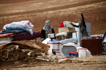 Palestinian Bedouins stand next to their belongings after Israeli soldiers demolished their tents in an area east of the village of Tubas, in the occupied West Bank, on November 3, 2020. (Jaafar Ashtiyeh/AFP)