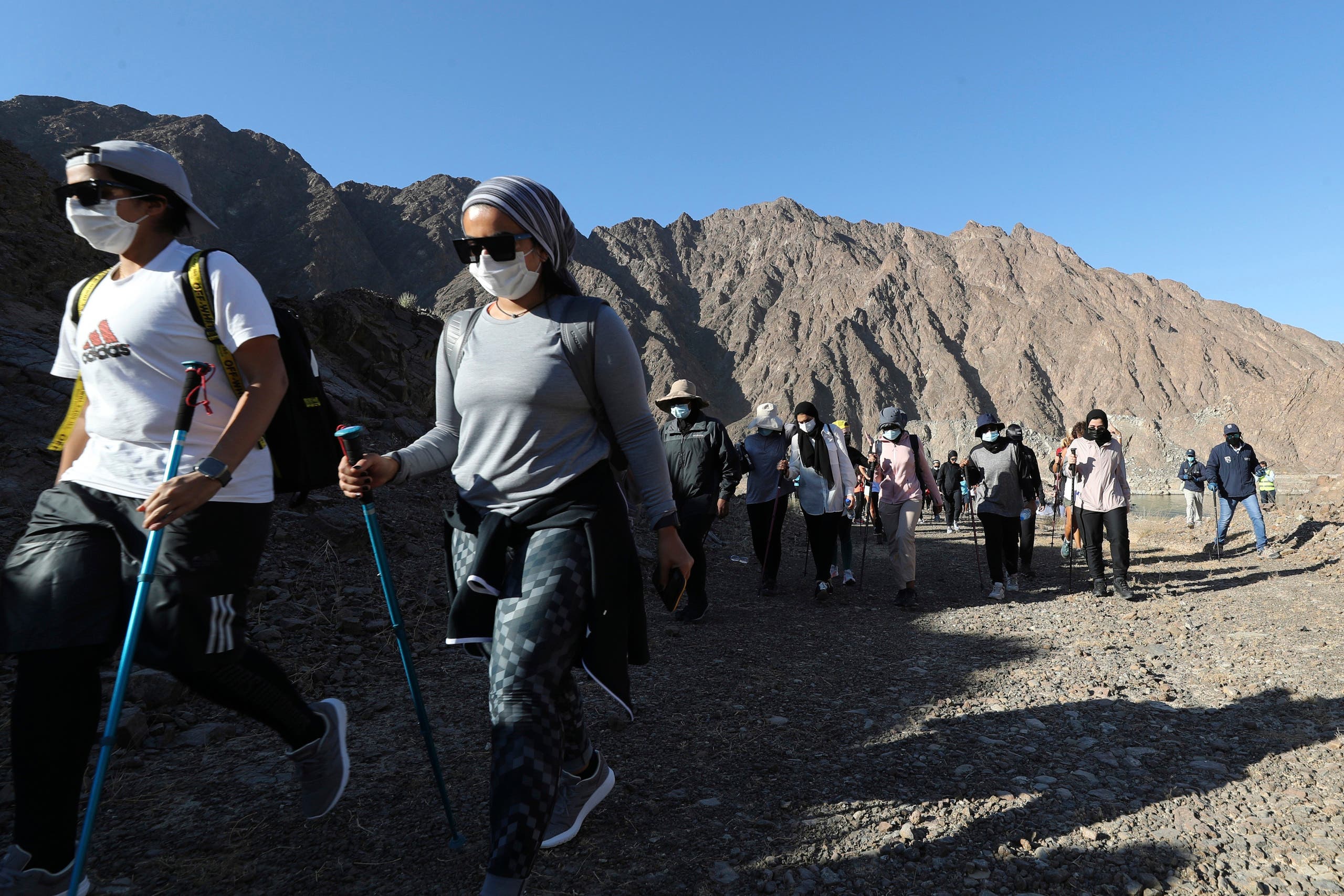Participants walk during the Women's Adventure Hatta organized by Dubai Sports Council in Hatta, United Arab Emirates on Oct. 23, 2020. (AP)