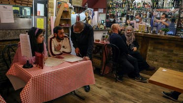 Customers and staff at Il Pagliaccio, an Italian restaurant, before closure ahead of the lockdown during the coronavirus disease (COVID-19) outbreak in Fulham, London, Britain November 4, 2020. (Reuters)