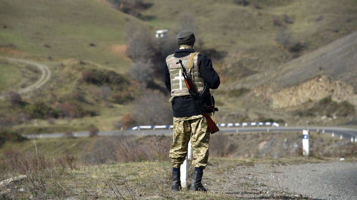 A military volunteer keeps watch in the Shusha region on October 31, 2020, amid the ongoing military conflict between Armenia and Azerbaijan over the breakaway region of Nagorno-Karabakh. 