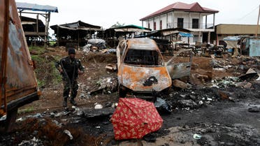 A Cameroonian elite Rapid Intervention Battalion (BIR) member walks past a burnt car while patroling in the city of Buea in the anglophone southwest region, Cameroon October 4, 2018. (Reuters)