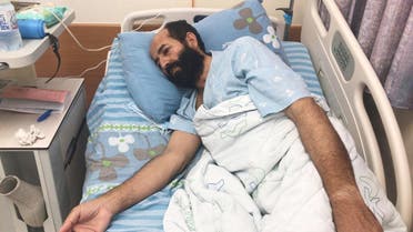 Maher Al-Akhras, 49, a Palestinian who began a hunger strike against his detention without charge by Israel, lies in a hospital bed in Rehovot, Israel October 13, 2020. (Reuters)