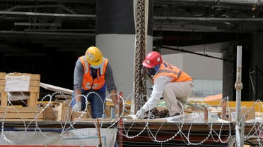 Foreign workers wearing protective face masks and gloves work at a construction site, following the outbreak of the coronavirus disease (COVID-19), in Riyadh. (Reuters)