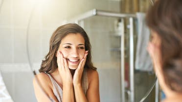 I've never looked this flawless! stock photo Cropped shot of a attractive young woman admiring her face while standing in front of the bathroom mirror at home