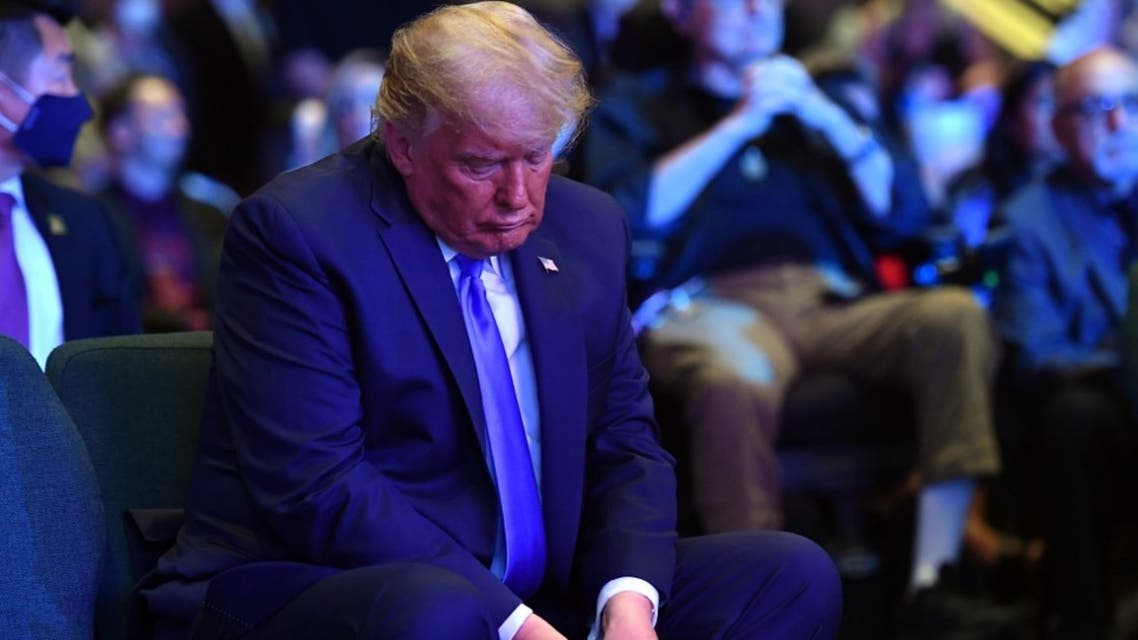 US President Donald Trump counts money before making an offering, as he attends services at the International Church of Las Vegas in Las Vegas, Nevada on October 18, 2020. (AFP)