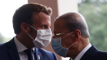 FILE PHOTO: FILE PHOTO: French President Emmanuel Macron and Lebanon's President Michel Aoun wear face masks as they arrives to attend a meeting at the presidential palace in Baabda, Lebanon September 1, 2020. REUTERS/Gonzalo Fuentes/Pool/File Photo