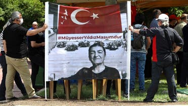 People hold up a banner as they gather to denounce the arrest of one of two journalists, Muyesser Yildiz, a news coordinator at OdaTV online news site, during a rally in Ankara on June 18, 2020. (Adem Altan/AFP)