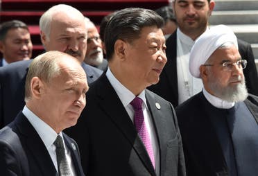 Russian President Vladimir Putin, Chinese President Xi Jinping and Iran's President Hassan Rouhani walk in Bishkek on June 14, 2019. (AFP)