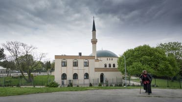 A Muslim woman walks by a mosque at Islam Centre of Vienna on April 14, 2017 in Vienna, Austria. (AFP)