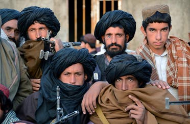 In this photograph taken on November 3, 2015, Afghan Taliban fighters look on as they listen to Mullah Mohammad Rasool Akhund (unseen), the newly appointed leader of a breakaway faction of the Taliban, at Bakwah in the western province of Farah. (AFP)
