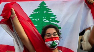 An anti-government protester shouts slogans while wearing a mask with the colors of the Lebanese flag in Beirut, Lebanon, Thursday, July 2, 2020. (File photo: AP)