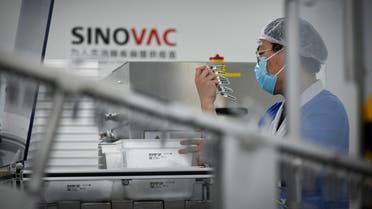 A staff member works during a media tour of a new factory built to produce a COVID-19 coronavirus vaccine at Sinovac in Beijing on September 24, 2020. (Wang Zhao/AFP)
