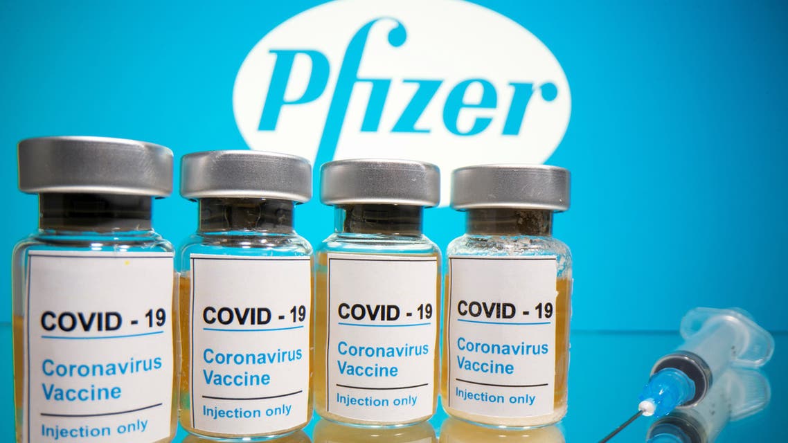 Vials with a sticker reading, COVID-19 / Coronavirus vaccine / Injection only and a medical syringe are seen in front of a displayed Pfizer logo in this illustration taken October 31, 2020. (Reuters)