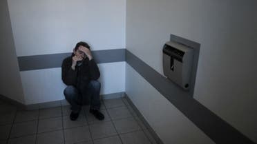A patient sits on the ground in a common room, 17 December 2006 in Saint Jean de Dieu pyschiatric hospital in Lyon. (AFP)