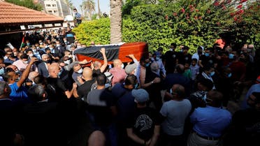 Mourners carry the coffin of chief Palestinian negotiator Saeb Erekat, who died after contracting the coronavirus, during his funeral in Jericho in the Israeli-occupied West Bank on November 11, 2020. (Reuters)