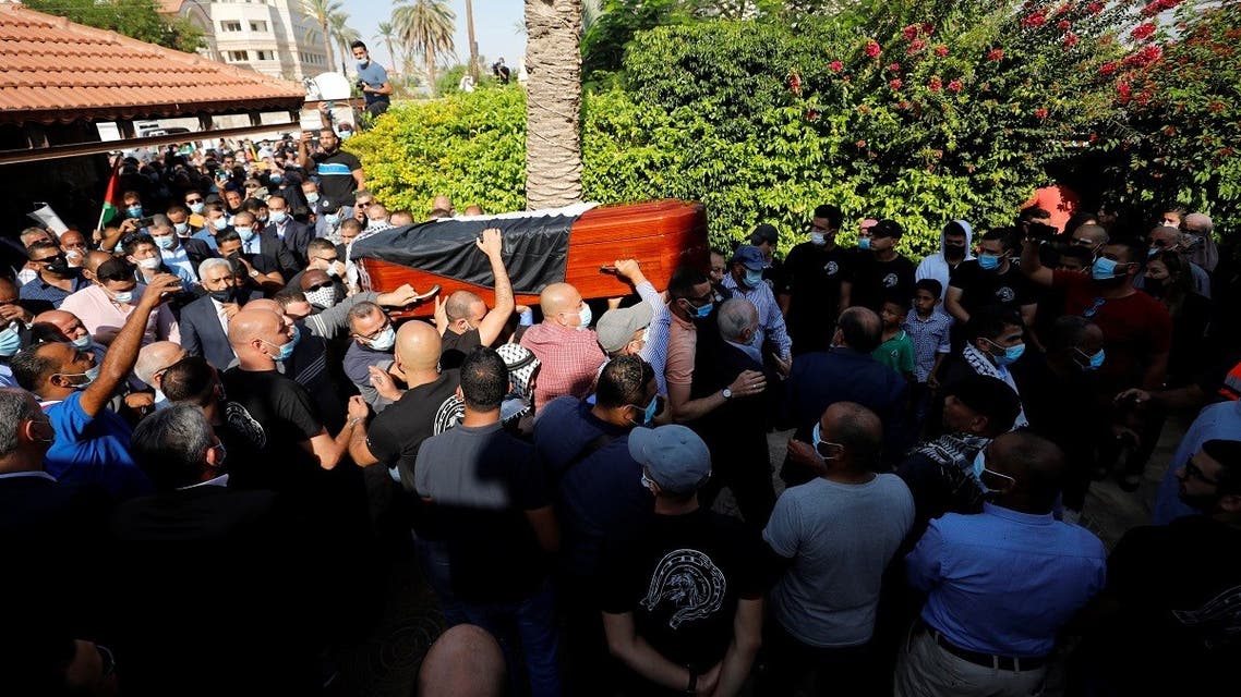 Mourners carry the coffin of chief Palestinian negotiator Saeb Erekat, who died after contracting the coronavirus, during his funeral in Jericho in the Israeli-occupied West Bank on November 11, 2020. (Reuters)