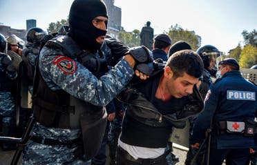 Armenian police officers detain a protestor during a rally against the country's agreement to end fighting with Azerbaijan over the disputed Nagorno-Karabakh region outside the government headquarters in Yerevan on November 11, 2020. (AFP)