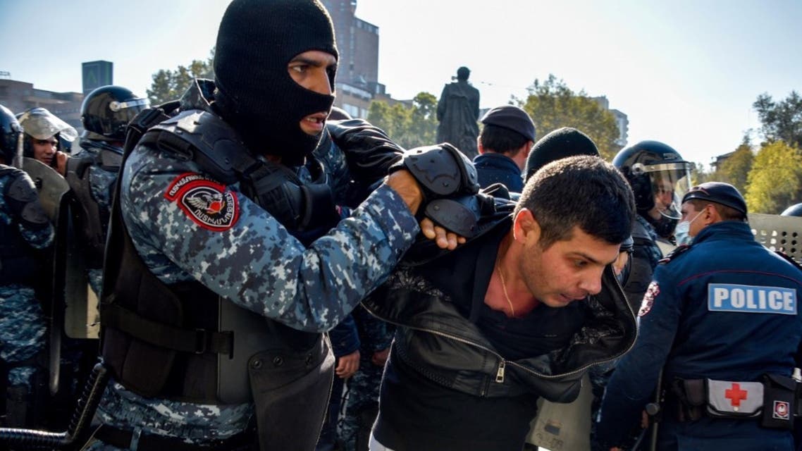 Armenian police officers detain a protestor during a rally against the country's agreement to end fighting with Azerbaijan over the disputed Nagorno-Karabakh region outside the government headquarters in Yerevan on November 11, 2020. (AFP)