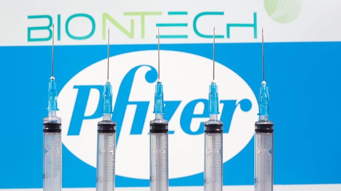Syringes are seen in front of displayed Biontech and Pfizer logos in this illustration taken November 10, 2020. (Reuters/Dado Ruvic/Illustration)