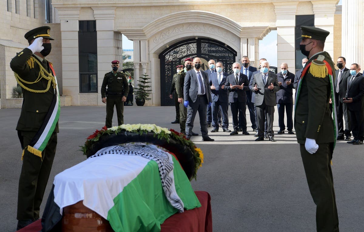 Palestinian President Mahmoud Abbas prays as honor guards salute next to the coffin of chief Palestinian negotiator Saeb Erekat, who died after contracting the coronavirus disease (COVID-19), during a ceremony in Ramallah in the Israeli-occupied West Bank November 11, 2020. (Reuters)