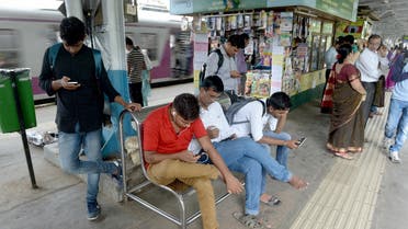 A file photo shows Indians surf the internet on their phones at a free wi-fi zone inside a suburban railway station in Mumbai on August 22, 2016. (Indranil Mukherjee/AFP)