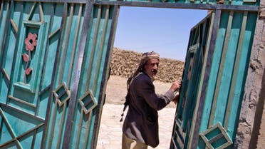 An unidentified Jewish man walks through the metal gate leading to a Jewish girls' school and makeshift synagogue in Kharif, Yemen. (File photo: AP)