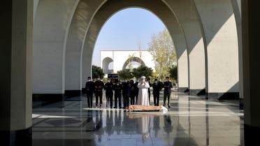 Mourners pray over the body of a person who died from COVID-19, at the Behesht-e-Zahra cemetery on the outskirts of the Iranian capital, Tehran, Iran, Sunday, Nov. 1, 2020. The cemetery is struggling to keep up with the coronavirus pandemic ravaging Iran, with double the usual number of bodies arriving each day and grave diggers excavating thousands of new plots. (AP Photo/Ebrahim Noroozi)
