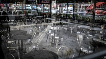 This photo taken on November 12, 2020, shows the empty terrace of a closed restaurant, seen through a window, on the Champs-Elysees avenue in Paris, during a second national lockdown in France. (AFP)