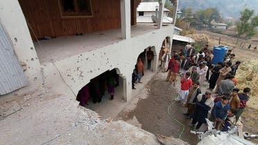 Locals gather near a house, which was damaged, according to them, by cross-border shelling, in Neelum Valley, in Pakistan-administrated Kashmir, on November 13, 2020. (Reuters)