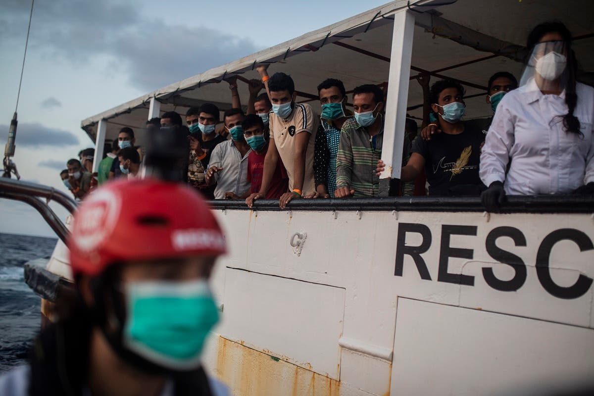 Migrants from different nationalities rest on board the Spanish NGO Open Arms vessel after being rescued as they were trying to flee Libya on board a precarious wooden boat, in international waters, in the Central Mediterranean sea. (AP)