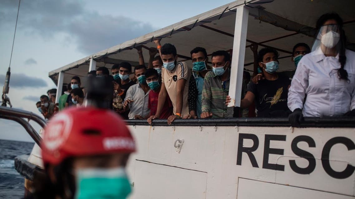Migrants from different nationalities rest on board the Spanish NGO Open Arms vessel after being rescued as they were trying to flee Libya on board a precarious wooden boat, in international waters, in the Central Mediterranean sea. (AP)
