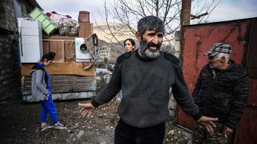 Armenians pack their belongings while leaving their house in the town of Kalbajar on November 12, 2020, during the military conflict between Armenia and Azerbaijan over the breakaway region of Nagorno-Karabakh. (Alexander Nemenov/AFP)