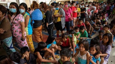 Residents affected by the onslaught of Typhoon Vamco queue for food in an evacuation center, in Rodriguez, Rizal province, Philippines, November 14, 2020. (Reuters)