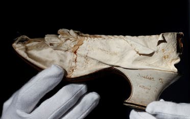 Osenat displays a shoe that belonged to late French queen Marie-Antoinette, in Versailles, near Paris, France, November 14, 2020. (Reuters/Christian Hartmann)