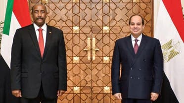 A picture released on October 27, 2020 shows Egyptian President al-Sisi (R) meeting with President of the Sudanese Sovereign Council General Abdel Fattah al-Burhan, at the presidential palace in the capital Cairo. (Egyptian Presidency/AFP)