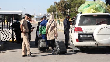 People in Libya cross to neighboring Tunisia via the Ras Jedir border post, after its reopening on November 14, 2020. (Mahmud Turkia/AFP)