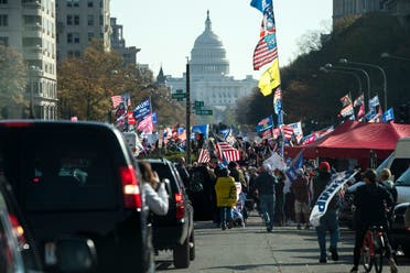 US President Donald Trump drives by a group of supporters participating in a rally near the White House, Nov. 14, 2020. (AP)
