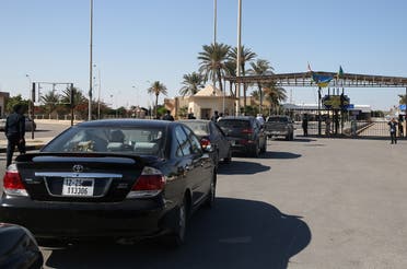 Cars in Libya cross to neighboring Tunisia via the Ras Jedir border post, after its reopening on November 14, 2020. (Mahmud Turkia/AFP)