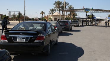 Cars in Libya cross to neighboring Tunisia via the Ras Jedir border post, after its reopening on November 14, 2020. (Mahmud Turkia/AFP)