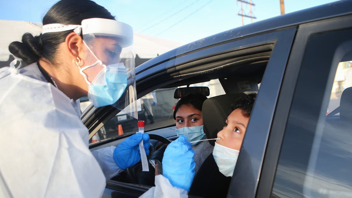 A frontline healthcare worker administers a nasal swab test at a drive-in COVID-19 testing in El Paso on November 13, 2020. (Mario Tama/Getty Images/AFP)