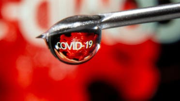 The word COVID-19 is reflected in a drop on a syringe needle in this illustration taken November 9, 2020. (Reuters)