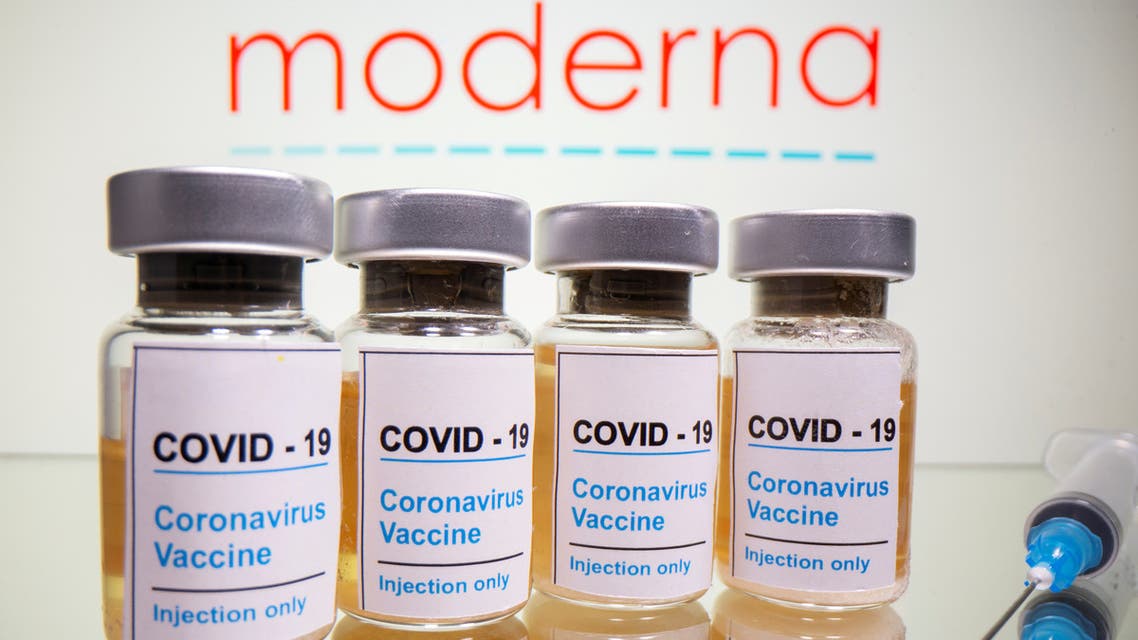 FILE PHOTO: Vials with a sticker reading, COVID-19 / Coronavirus vaccine / Injection only and a medical syringe are seen in front of a displayed Moderna logo in this illustration taken October 31, 2020. REUTERS/Dado Ruvic/Illustration/File Photo