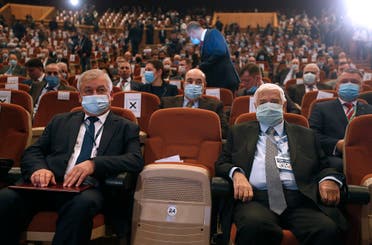 Russia's special envoy on Syria Alexander Lavrentiev (L) sits next to Syrian FM Walid al-Muallem at the opening session of the international conference on the return of refugees held in Damascus on Nov. 11, 2020. (AFP)