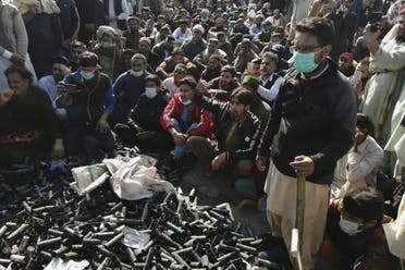 Activists and supporters of Tehreek-e-Labbaik Pakistan (TLP), a religious party, gather beside empty tear gas shells fired by police during an anti-France demonstration in Islamabad on November 16, 2020. (AFP)