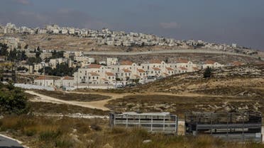 Israel's controversial concrete barrier (C) separating the Jewish settlement of Neve Yaakov (foreground) in the northern part of east Jerusalem and the Palestinian area of al-Ram (background) in the occupied West Bank. (AFP)