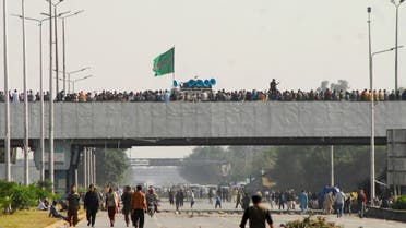 Supporters of religious and political party Tehreek-e-Labaik Pakistan (TLP) gather on a bridge as they block roads during a protest against the cartoon publications of Prophet Mohammad in France, in Islamabad, Pakistan, on November 16, 2020. (Reuters)