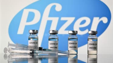 An illustration picture shows vials with Covid-19 Vaccine stickers attached and syringes with the logo of US pharmaceutical company Pfizer, on November 17, 2020. (AFP)